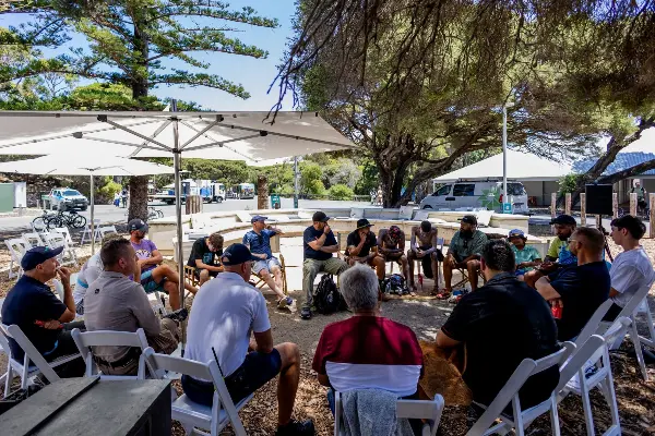 A group of men in a yarning circle.