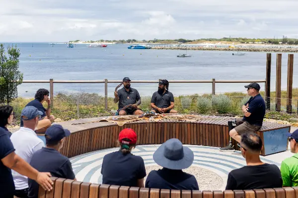 A group of people have a yarn on Wadjemup.