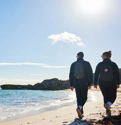Smartreka | couple walking on the beach in winter on Rottnest Island